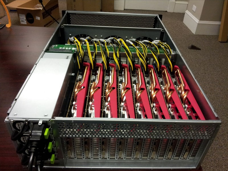 A server rack filled with multiple GPUs connected by yellow and black cables, illustrating the complexity and power needed to crack a 20-character code in 766 trillion years.