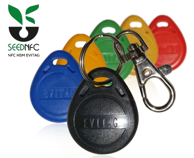 Multiple NFC HSM EviTag devices with key rings and chrome carabiners, available in black, green, orange, yellow, red, and blue, alongside the SeedNFC logo.