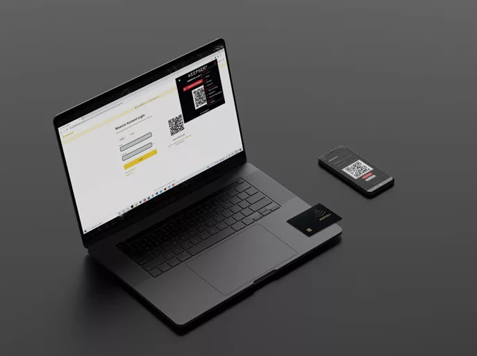 Keepser NFC Cold Wallet card alongside a laptop displaying a QR code and a smartphone.