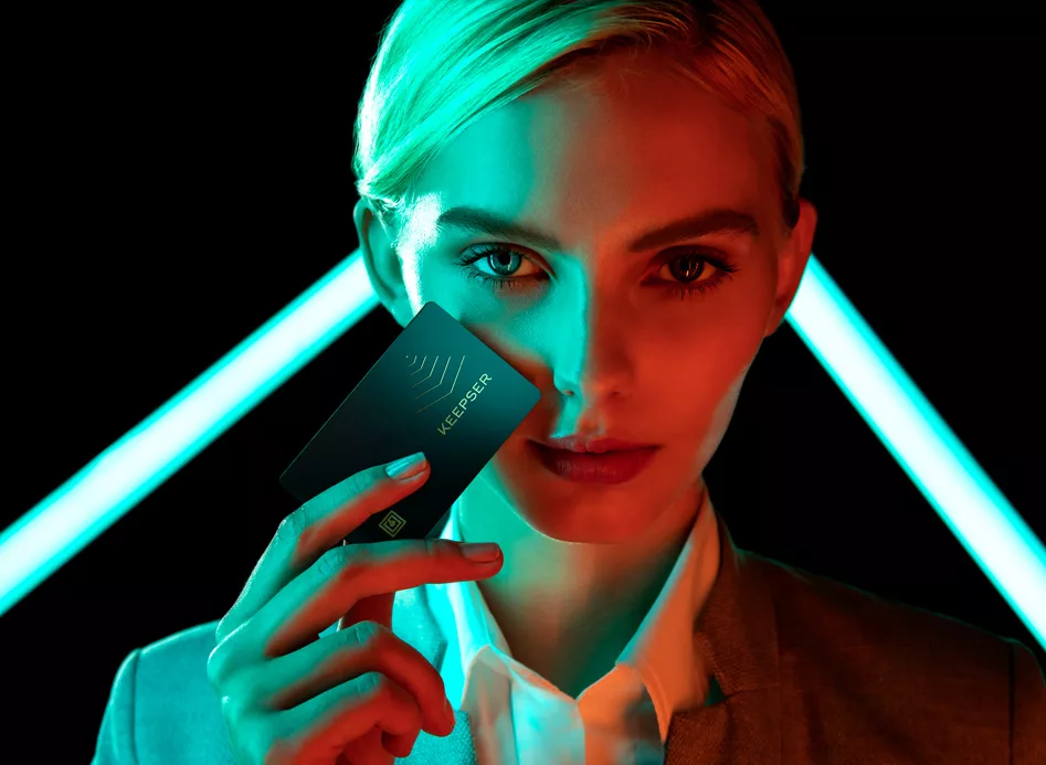 Woman holding a Keepser NFC Crypto Hardware Wallet illuminated by neon lights, showcasing 6 Reasons Why Keepser is the ultimate choice for security.